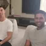 Cristiano Ronaldo, con la camiseta del Al Nassr, sonríe durante un partido de fútbol en un estadio.