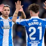 Mario Soriano y el dorsal 21 del Deportivo celebran un gol en el estadio de Riazor con el mensaje Força València en sus camisetas