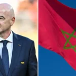 Gianni Infantino con traje de FIFA junto a la bandera de Marruecos ondeando