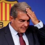 Joan Laporta se lleva la mano a la frente en una comparecencia ante el escudo del FC Barcelona